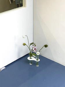 Artistic test tube vase with minimalist white acrylic base and twin glass floral holders
