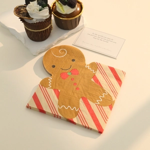 Close-up of gingerbread man shaped paper napkins for Christmas party table decor