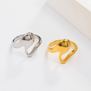 Detail shot of irregular fluid design rings in 18K gold and silver polished finishes