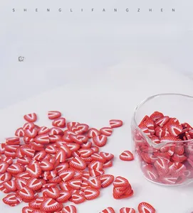 Macro shot of realistic DIY strawberry polymer clay slices for crafting and nail art decoration
