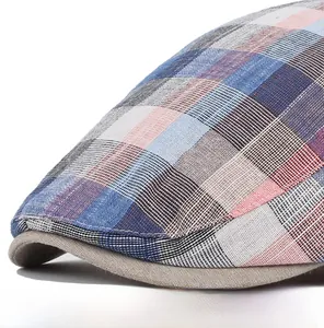 Detailed view of the plaid fabric texture and beige brim of this unisex flat cap