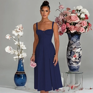 Detail view of navy blue midi dress with pleated bust and slim fit waist design