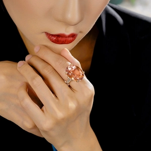 Elegant champagne pink oval morganite ring with micro-pave diamond accents on silver band