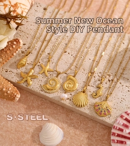 Detailed macro of gold stainless steel ocean shell pendants with pearls and zircons