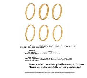 Macro view of gold stainless steel bangle set with zircons and various geometric patterns