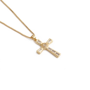 Close-up of gold cross pendant with rectangle zircons and a classic box chain