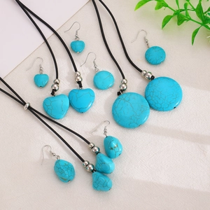 Vintage turquoise jewelry set with heart and round pendants on black cord necklace