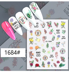 Detail of floral nail art stickers with hand-painted flowers and green leaf patterns