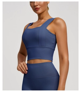 Detail of high-waist yoga leggings and square neck sports bra in deep blue navy