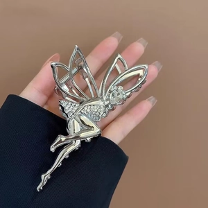 Silver angel wings hair claw clip with rhinestones shown on model for elegant hairstyle