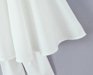 Close-up of white princess dress pleated hem with high-quality textured fabric