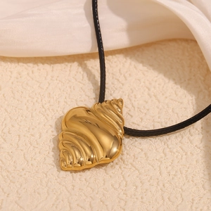 Close-up of a 18K gold plated shell pendant with elegant black wax cord necklace
