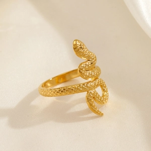 Minimalist gold snake-shaped stainless steel ring with detailed scale textures on silk