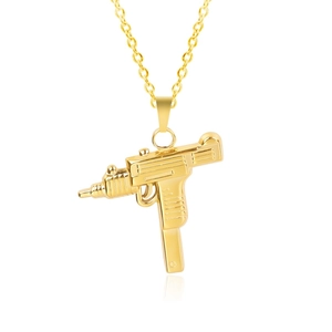 Detail shot of golden Uzi machine gun pendant on a cross chain with reflection