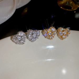 Macro shot of 18k gold plated heart stud earrings with sparkling pavé cubic zirconia