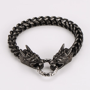 Detailed close-up of double dragon head vintage steel bracelet with intricate textures