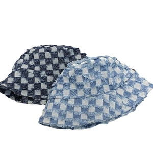 Denim checkerboard bucket hats in blue and light blue with trendy frayed edges