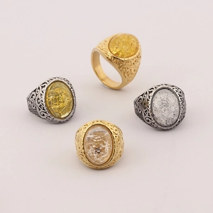 Detailed view of Viking rune rings with cracked gemstones and vine relief in gold and silver