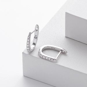 Macro shot showing the 925 silver hallmark and clear zircon row on a silver stud earring