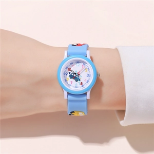 Close-up of kids quartz watch with light blue strap and 3D car motifs on wrist