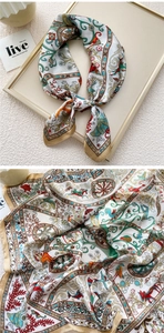 Detail of vintage carriage print silk scarf with golden borders and elegant floral patterns