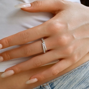 Detailed view of silver wrap ring with rectangular cubic zirconia stones on model finger