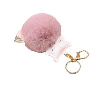 Pink plush fox keychain with cartoon animal charm and gold metal ring on white background