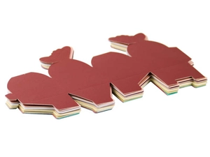 Flat-lay stack of laser-cut butterfly candy boxes in burgundy, beige, and light blue