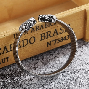 Detail of vintage punk snake head bracelet with flexible spiral steel band structure