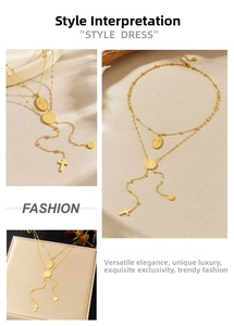 Close-up of layered gold necklace featuring cross pendants and embossed coin charms