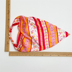 Detailed view of pink floral elastic headscarf with measuring ruler showing size 35x30cm