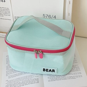 Mint green mesh cosmetic bag with pink zipper details and portable handle for travel