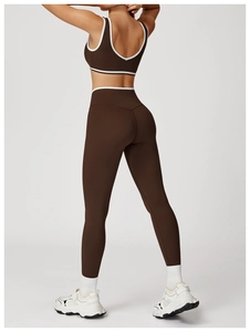 Detailed back view of high-waist cross yoga set with white contrast trim on dark brown fabric