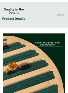 Detail of wooden jewelry tray with green velvet slots displaying a gold gemstone ring