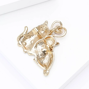 Detail view of the golden metal alloy brooch back showing the pin closure mechanism