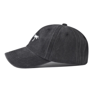 Detailed embroidery of a palm tree on washed vintage-style denim baseball cap