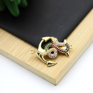 Close-up of gold snake and anchor pendant with colorful micro-paved cubic zirconia