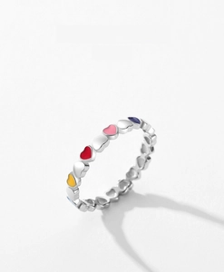 Macro detail of S925 sterling silver ring with colorful heart-shaped enamel pattern