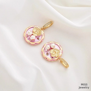 Macro view of vintage oil painting style flower pendants with pearls on white silk fabric