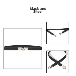 Detail of slim black elastic waist belt for women with silver interlocking metal buckle
