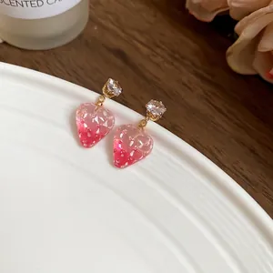 Sweet pink resin strawberry drop earrings with sparkling zircon studs on ceramic plate