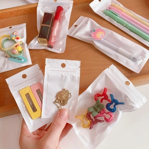 White self-sealing storage bags with hanging holes for jewelry and stationery items