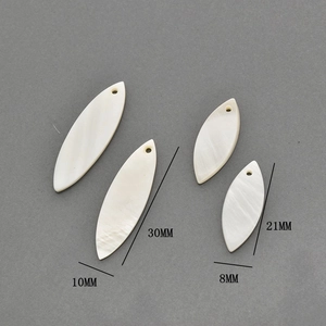 Macro view of marquise-shaped natural white shell charms for DIY jewelry making