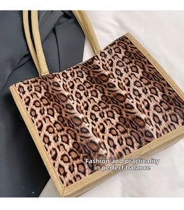 Close-up detail of leopard print tote bag with woven trim and durable canvas texture