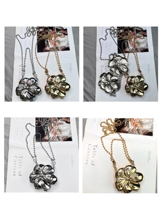 Detail shot of mini metal flower purses in gold and silver with elegant ball chain straps