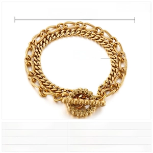 Detail view of gold double-layer stainless steel chain bracelet with a toggle clasp design