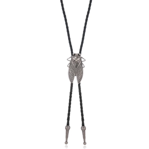 Detailed view of vintage silver cicada bolo tie with black braided leather rope