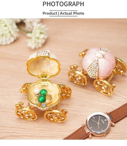 Detailed view of pumpkin carriage jewelry boxes with inlaid rhinestones on wood