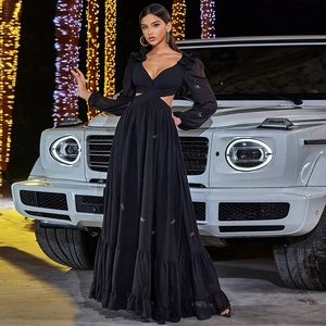Detailed close-up of the waist cut-out and ruffle sleeves on this elegant black maxi dress