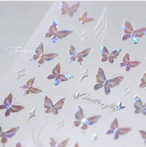 Macro view of holographic butterfly nail stickers with laser gold aurora metallic finish